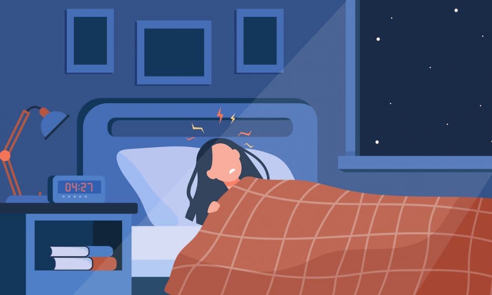 Depressed sleepless woman lying in bed Could smart beds help predict the onset of COVID-19?