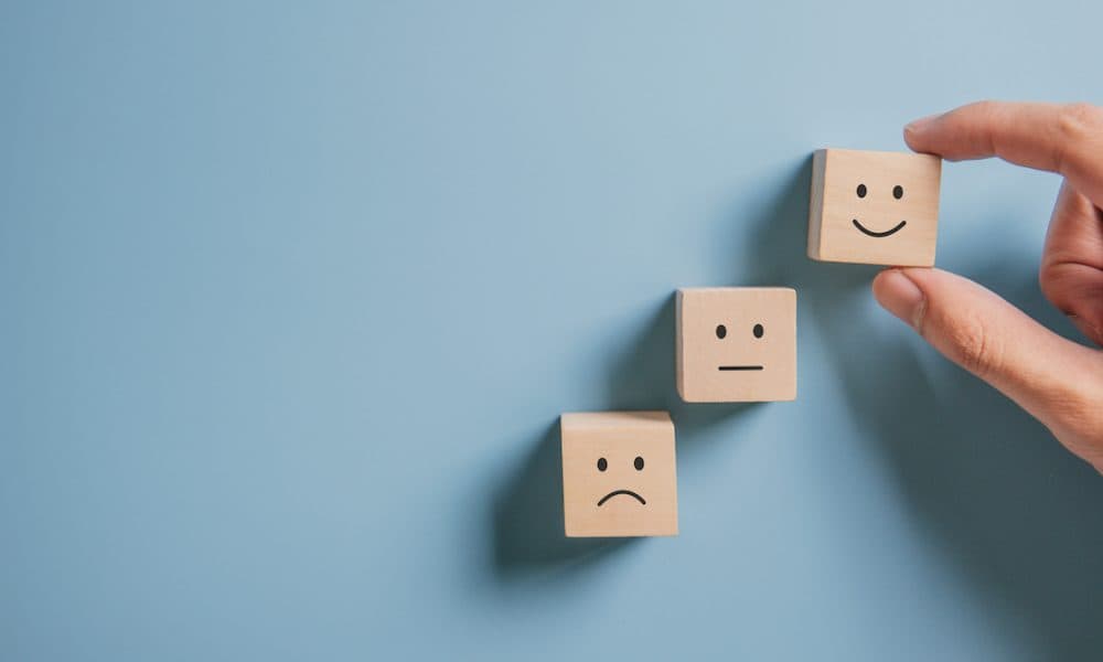 customer-showing-rating-with-happy-icon-blue-customer-satisfaction-survey-concept Five technologies changing the mental health landscape