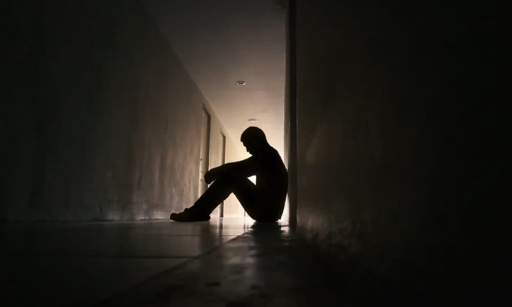 Silhouette,Of,Depressed,Man,Sitting,On,Walkway,Of,Residence,Building. Suicidal thoughts and self harm ‘on the rise’