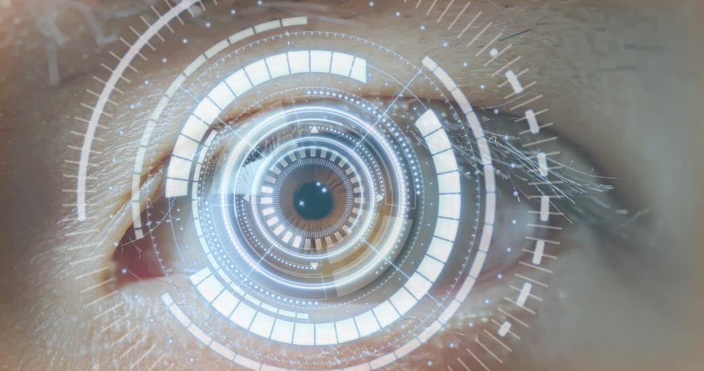 Eyes: A white male's left blue eye with a technical white pattern over it.