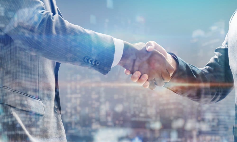 handshake of business people with skyscrapers background and fin Alpine Immune Sciences appoints Andrew S. Sandler, M.D. as CMO