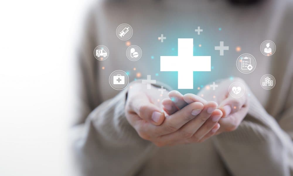 Woman hand holding plus icon for the healthcare medical icon. He The future of healthcare delivery is with patient engagement systems