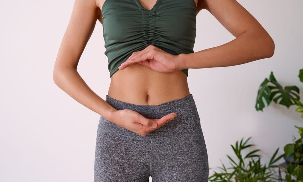 Cropped shot of a young multi-ethnic woman’s stomach cupped by her hands Research sheds light on connection between microbiome and kidney stones