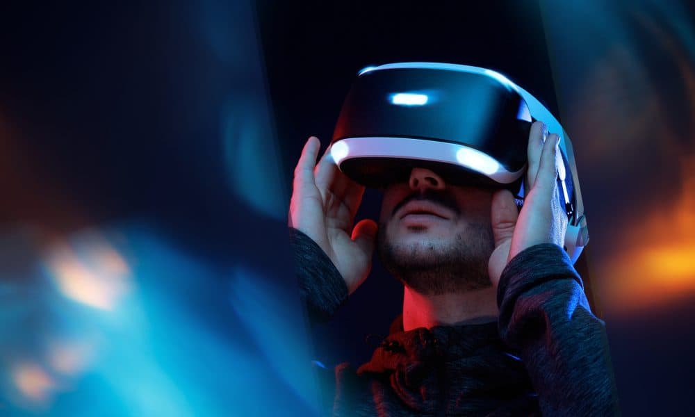 Model young man with beard in glasses of virtual reality. Augmen VR study reveals how pain and fear weaken sense of body ownership