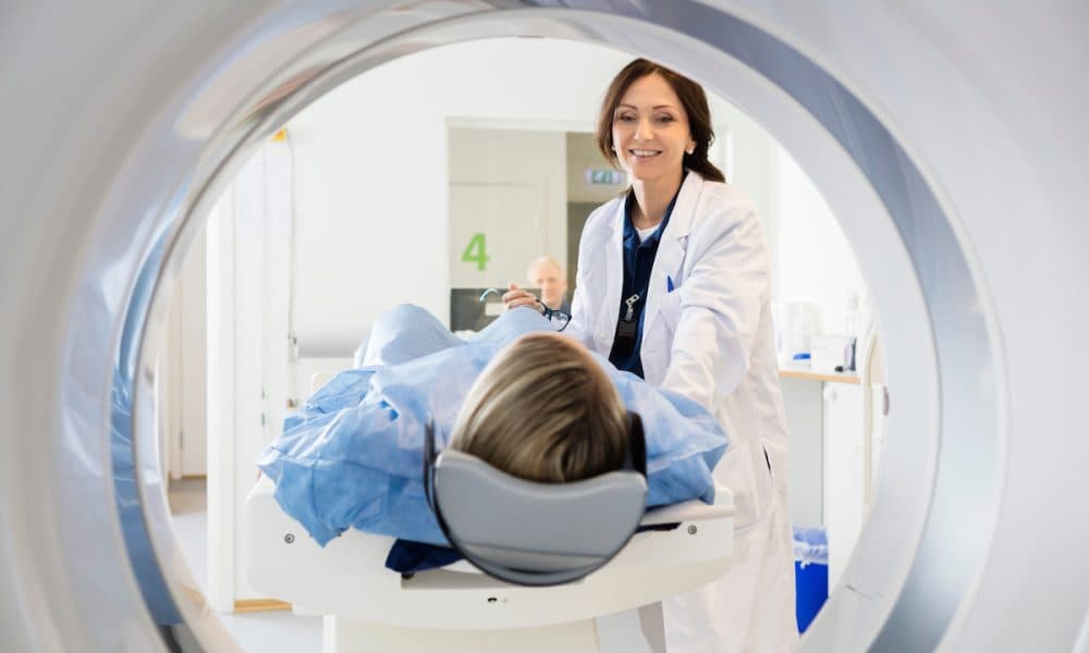 Female Doctor Looking At Patient Undergoing CT Scan Machine learning enables safer, cheaper and greener MRI