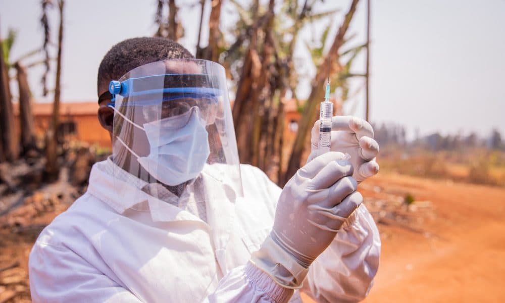 A doctor in Africa checks the vaccine syringe Tackling Malaria could bring major global economic boost, says new report