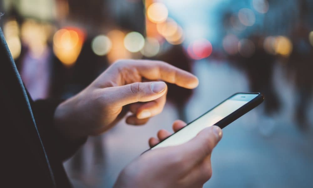 Closeup of male hands typing an sms message via smartphone outsi Researchers find better way to detect when older adults fall at home