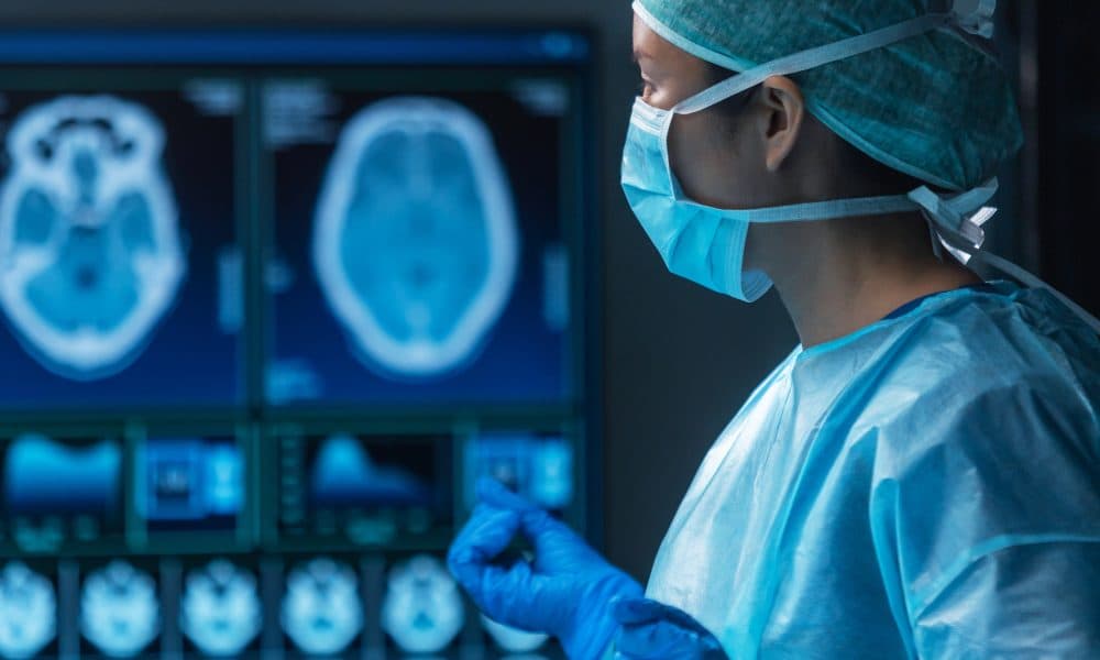 Team of medical doctors performs surgical operation in modern operating room using high-tech technology. Surgeons are working to save the patient in the hospital. Medicine, health and science. Leeds becomes first hospital in UK to benefit from revolutionary brain tumour tech