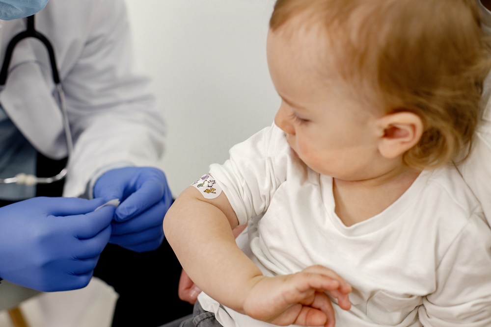 Cropped photo of a boy’s shoulder with stick band-aid vaccination UK worst in G7 for MMR vaccination, as 30m children not fully immunised